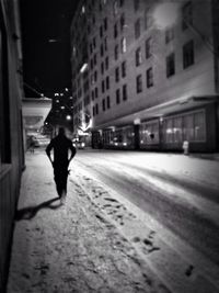 Woman walking in city at night