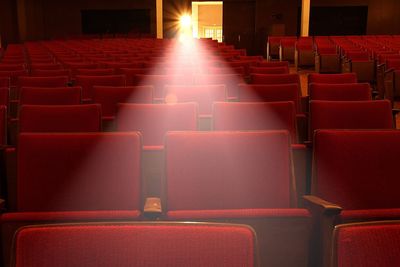 Light falling from projector on seats of movie theater