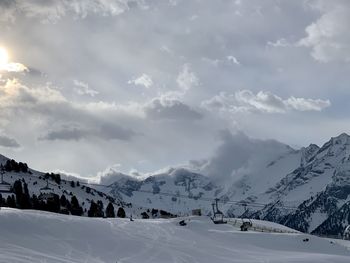 Scenic view of snow covered mountains against sky