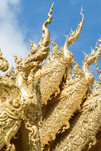 Low angle view of angel statue against sky