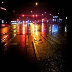 Illuminated city street at night