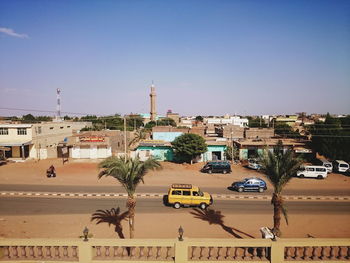 High angle view of city street against clear blue sky