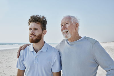 Senior man with adult son on the beach