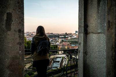 Rear view of woman looking at cityscape