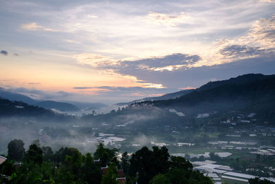 Scenic view of town against sky during sunset