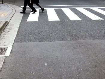 Low section of people walking on road