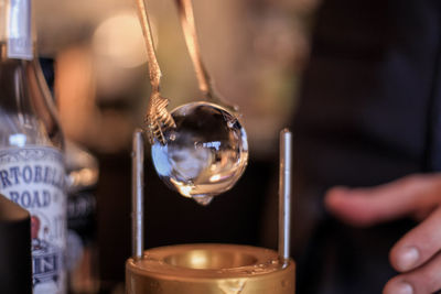 Close-up of ice ball with person in background