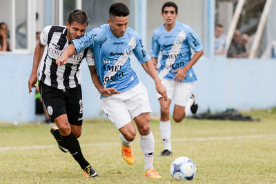 People playing soccer on field