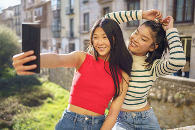 Portrait of young woman using mobile phone