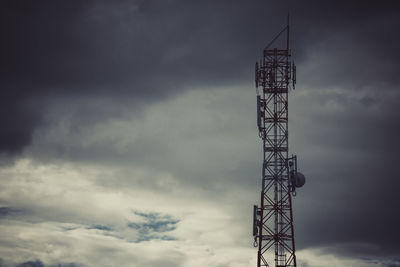Low angle view of communications tower against sky