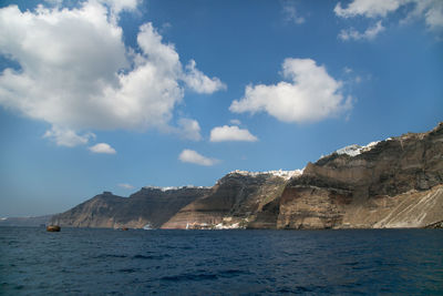 Scenic view of sea and mountains against sky