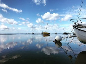 Boats moored on sea against sky