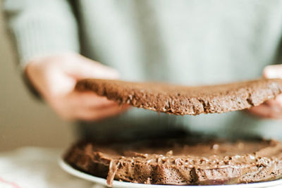 Woman cooking a chocolate cake in kitchen at home.