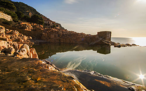 Scenic view of sea and rock formation against sky