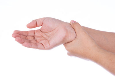 Close-up of human hand against white background