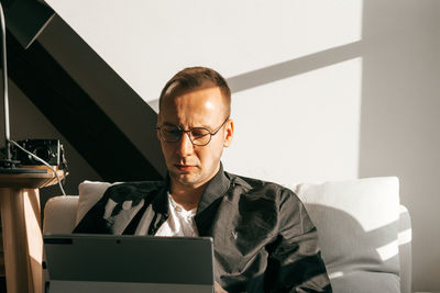 Portrait of man sitting on chair