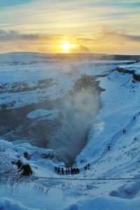 People walking on snow covered landscape