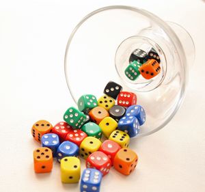 Close-up of colorful dice spilling from container