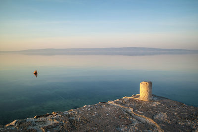 Scenic view of sea against sky at sunset