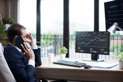 Young woman using mobile phone in office