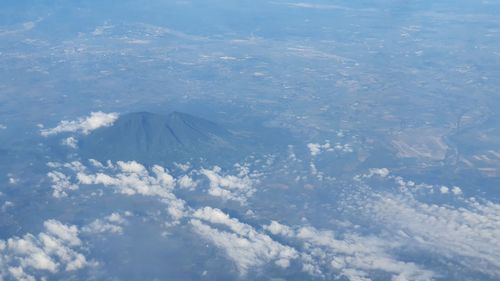 Aerial view of sea and landscape against sky