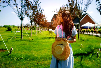 Rear view of woman standing on field