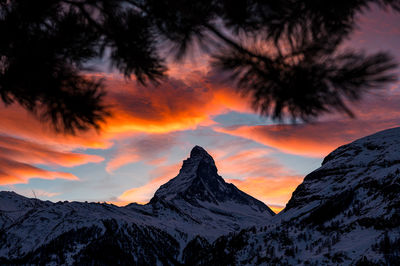 Scenic view of snowcapped mountains against sky during sunset