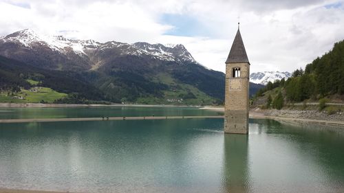Bell tower in reschensee against sky