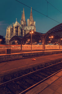 Illuminated railroad station in city at night