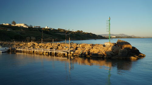 Scenic view of sea against clear blue sky