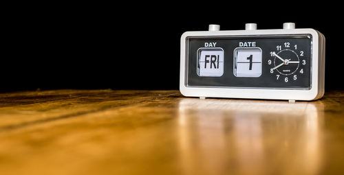 Close-up of clock on table at home
