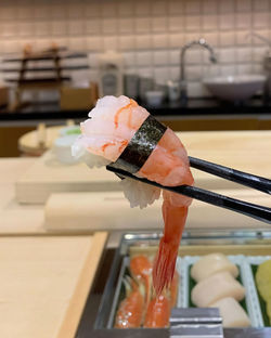 Close-up of a holding shrimp sushi