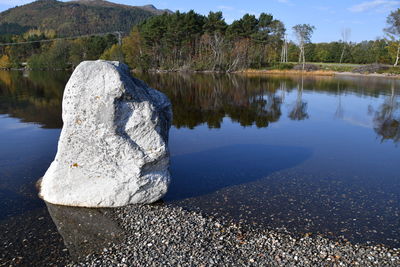 Scenic view of rocks on beach against sky