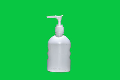 Close-up of bottle against green background