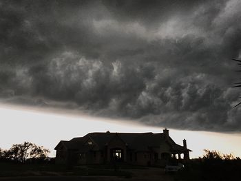 Houses against cloudy sky