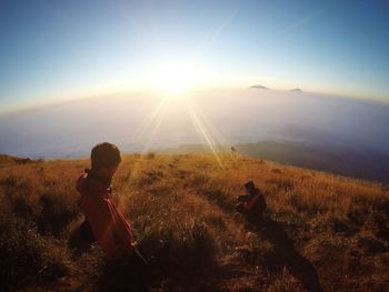 Scenic view of landscape against bright sun