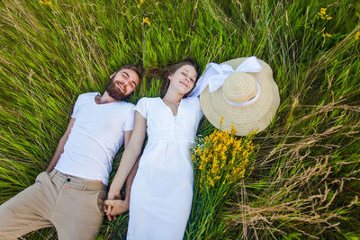 Full length of couple on field