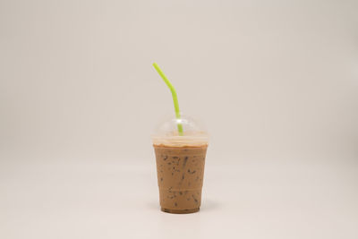 Close-up of drink in jar against white background