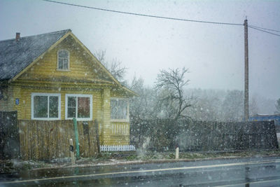 Buildings seen through wet window during rainy season