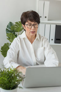 Portrait of doctor using laptop at home