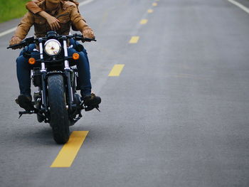 Man riding motorcycle on road