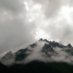 Scenic view of mountains against cloudy sky