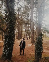 Full length of man standing in forest