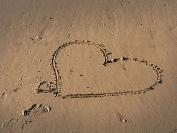High angle view of heart shape on sand at beach