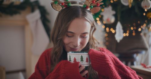 Close-up of young woman looking away at home