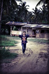 Full length portrait of young man walking outdoors