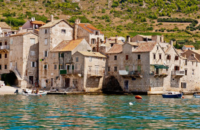 Old stone houses in the port of komiza, island vis,  croatia.