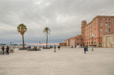 Group of people on street against buildings