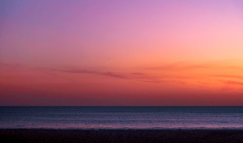 Scenic view of tranquil sea against sky during sunset