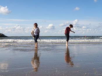 Full length of woman on beach against sky